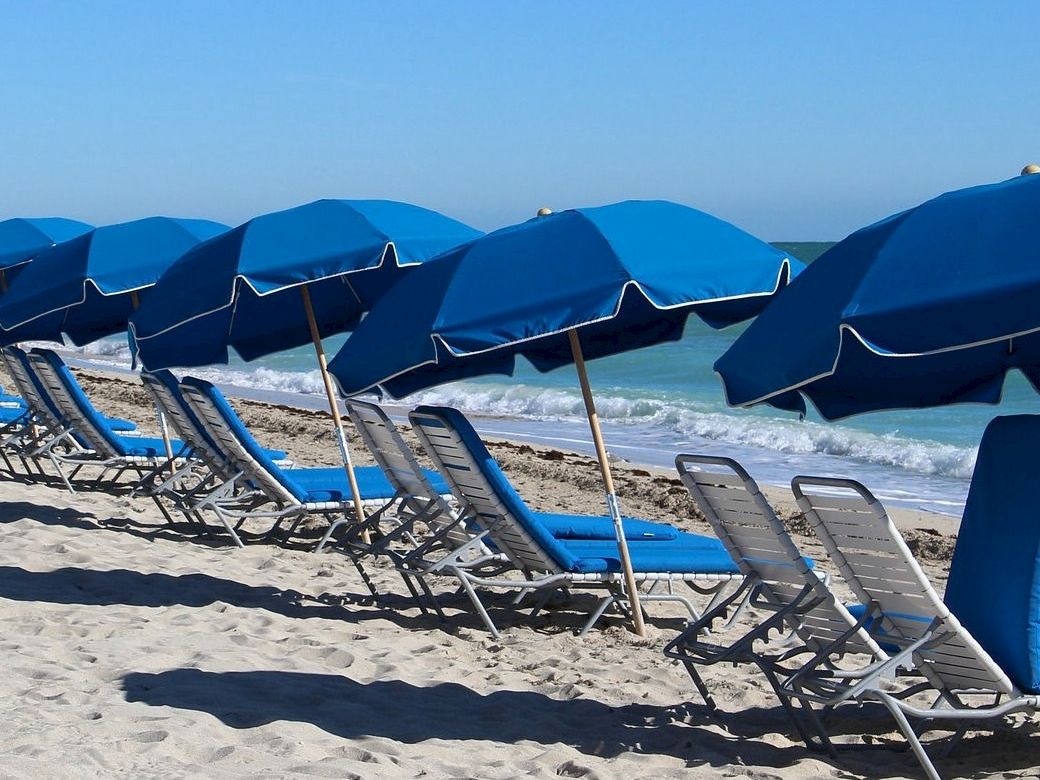 Blue beach chairs and umbrellas on Miami Beach